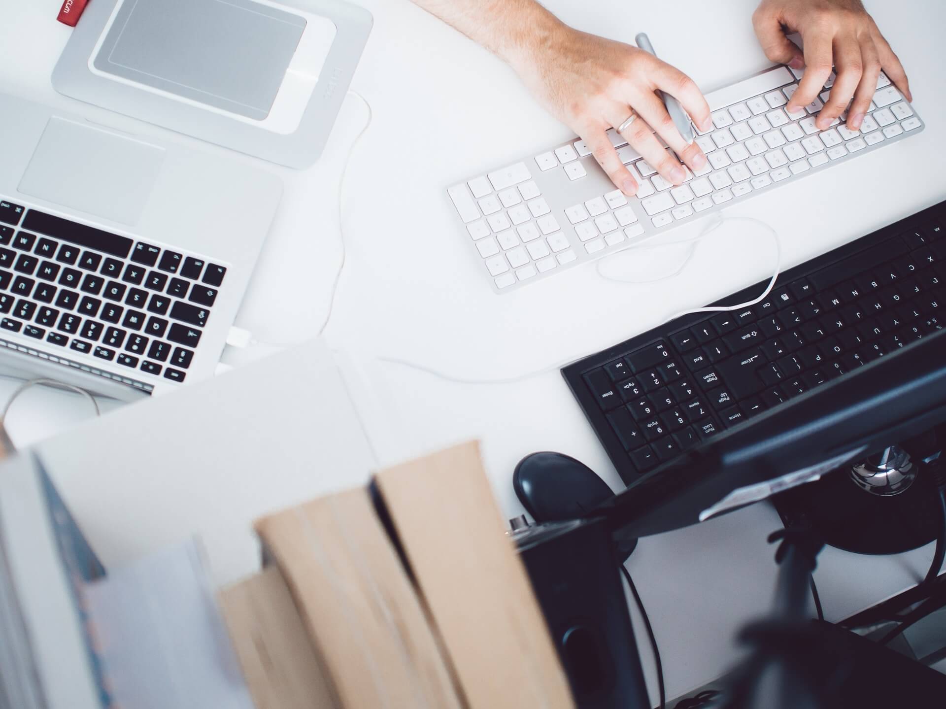 A person is using their computer on the desk